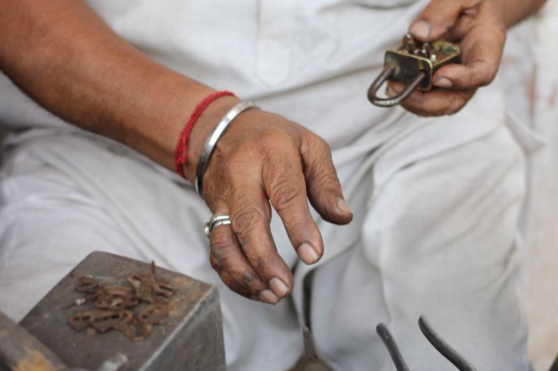 Locksmith repairing a lock by hand